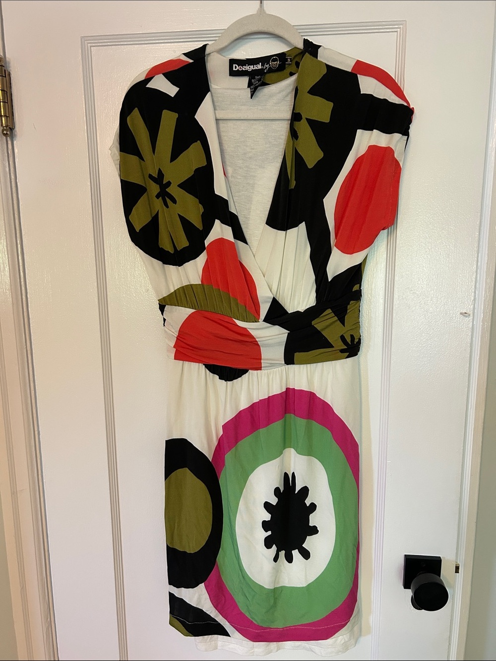 Desigual Wrap top cap sleeve dress. Graphic bold pattern. Fully lined. Side zip